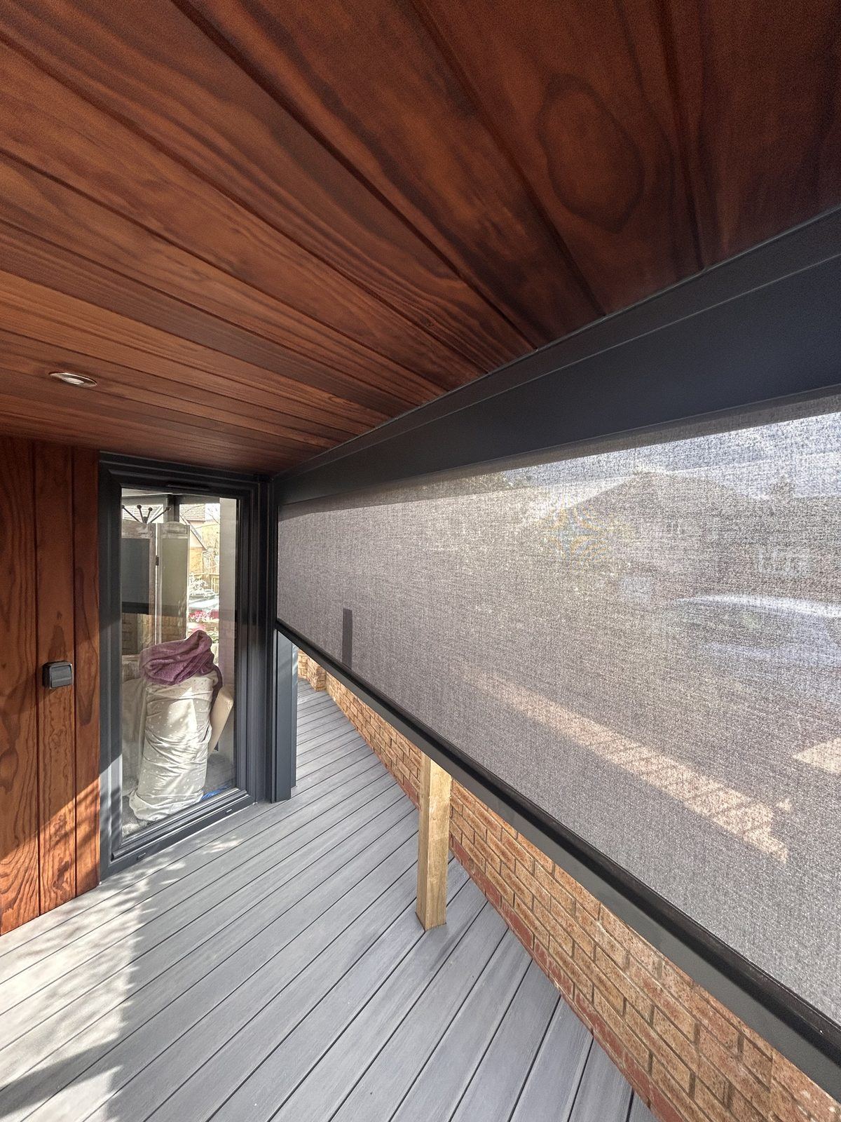 External electric roller blind installed to a garden room
