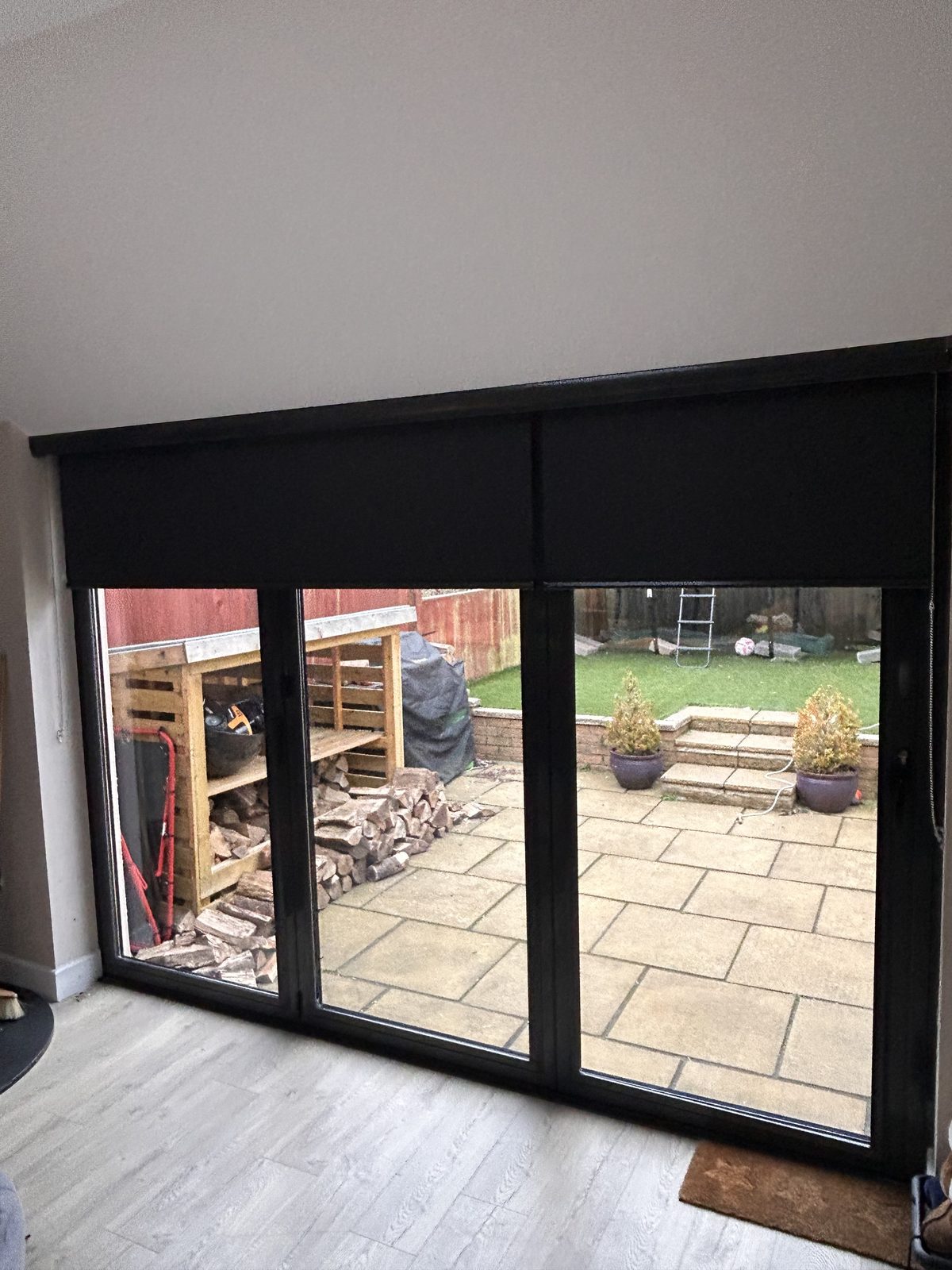 Roller blinds fitted to sliding doors in a living room