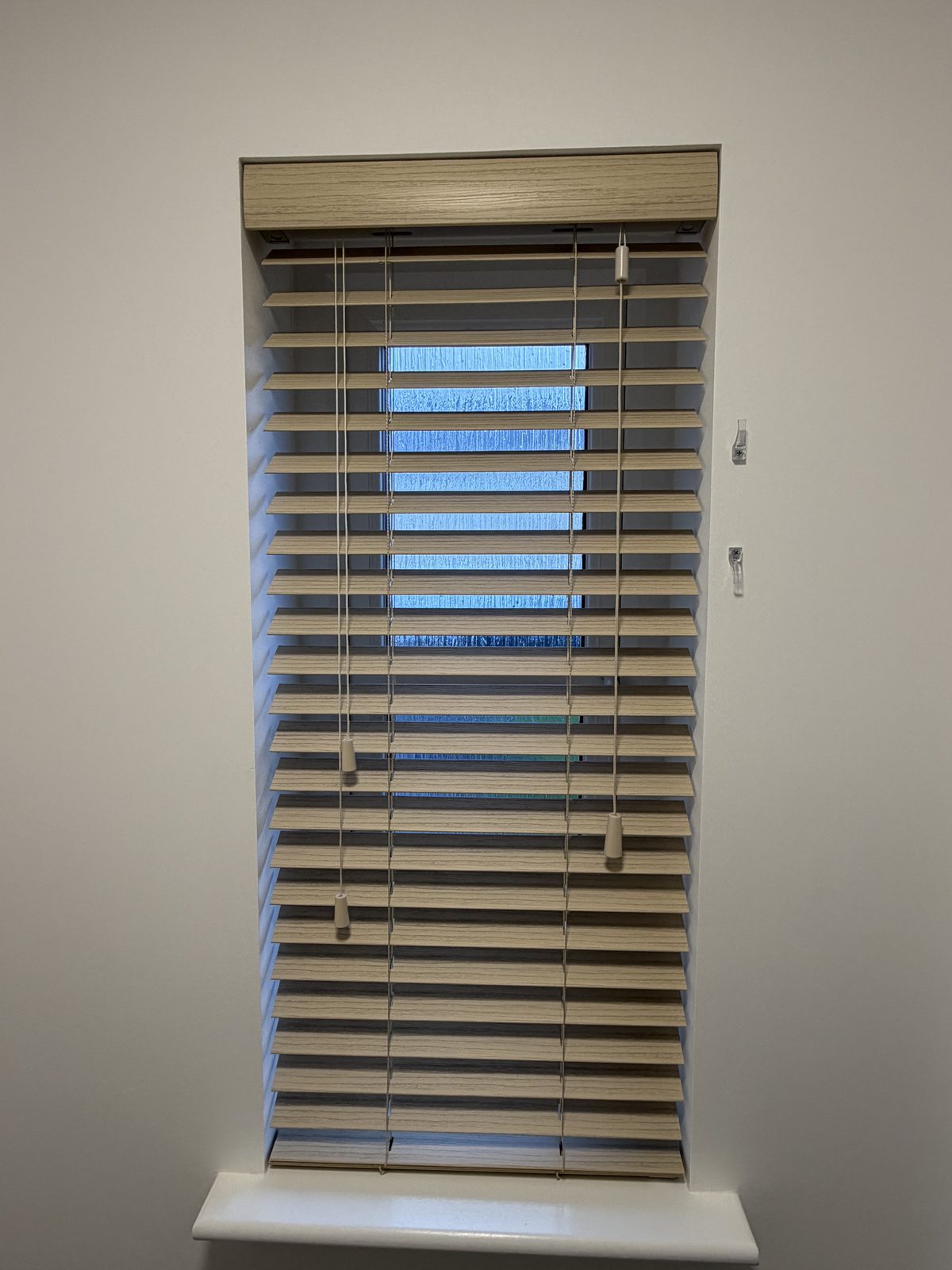 Wooden blind fitted to a narrow window
