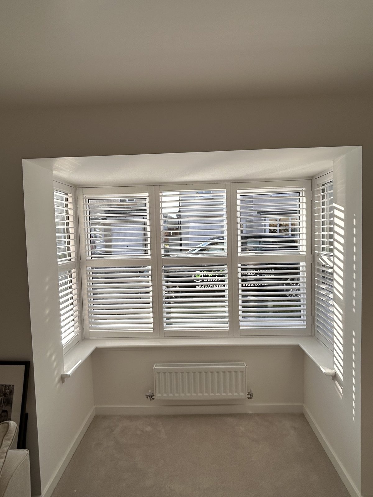 Wooden shutters fitted to a bay window