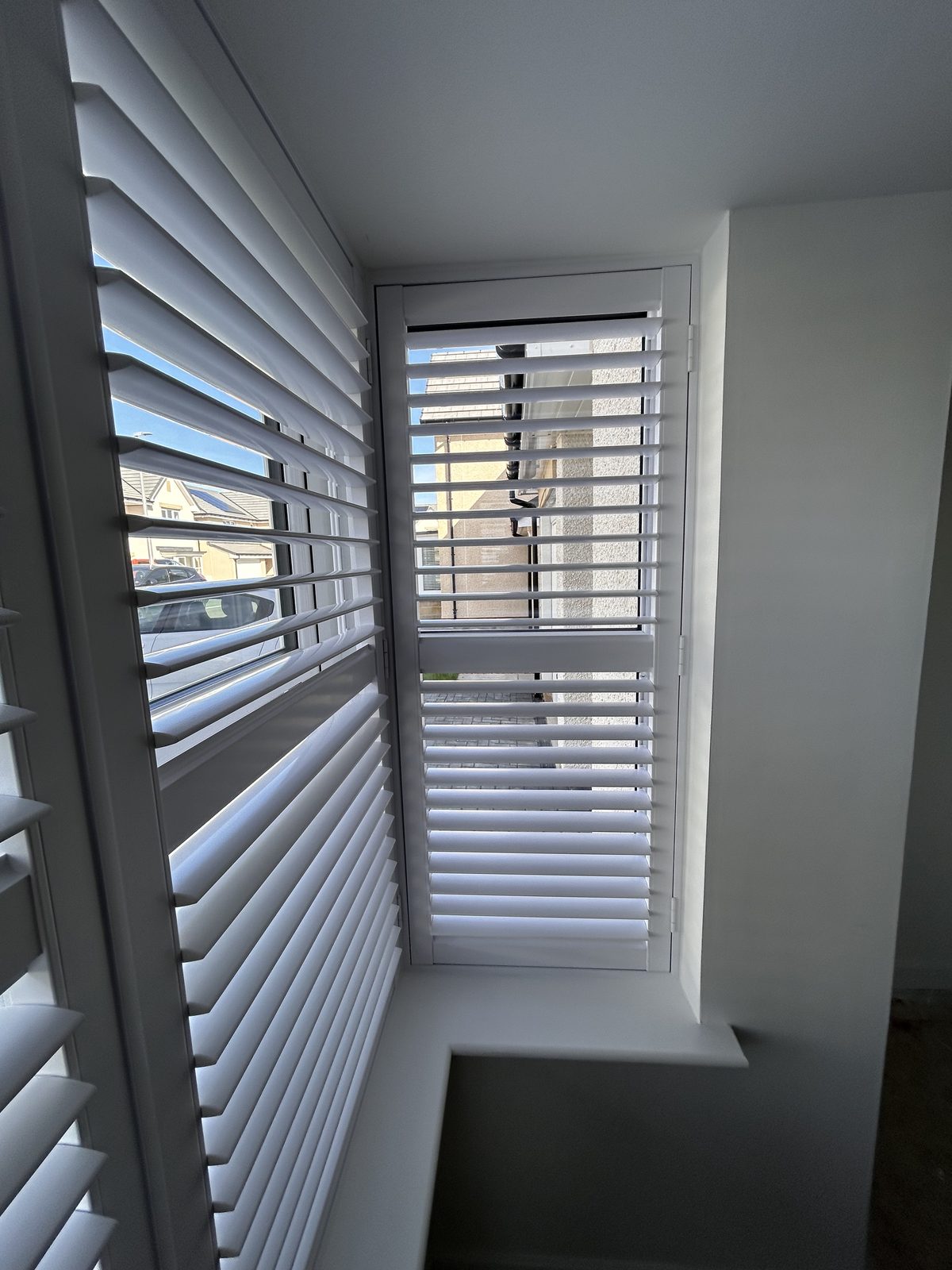 Wooden blinds fitted to a bay window in a new build home