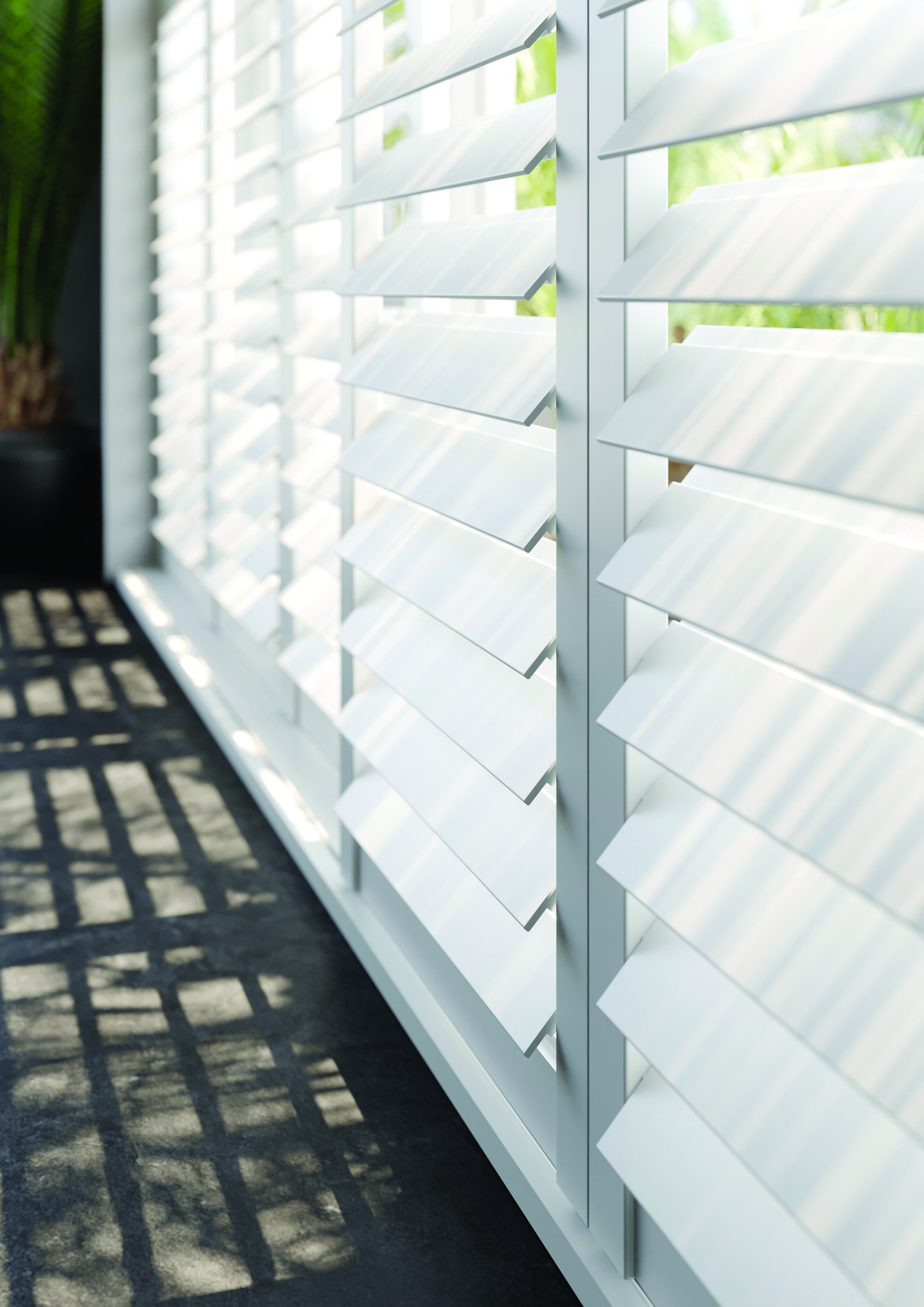 Close-up of wooden shutter louvres with a garden view